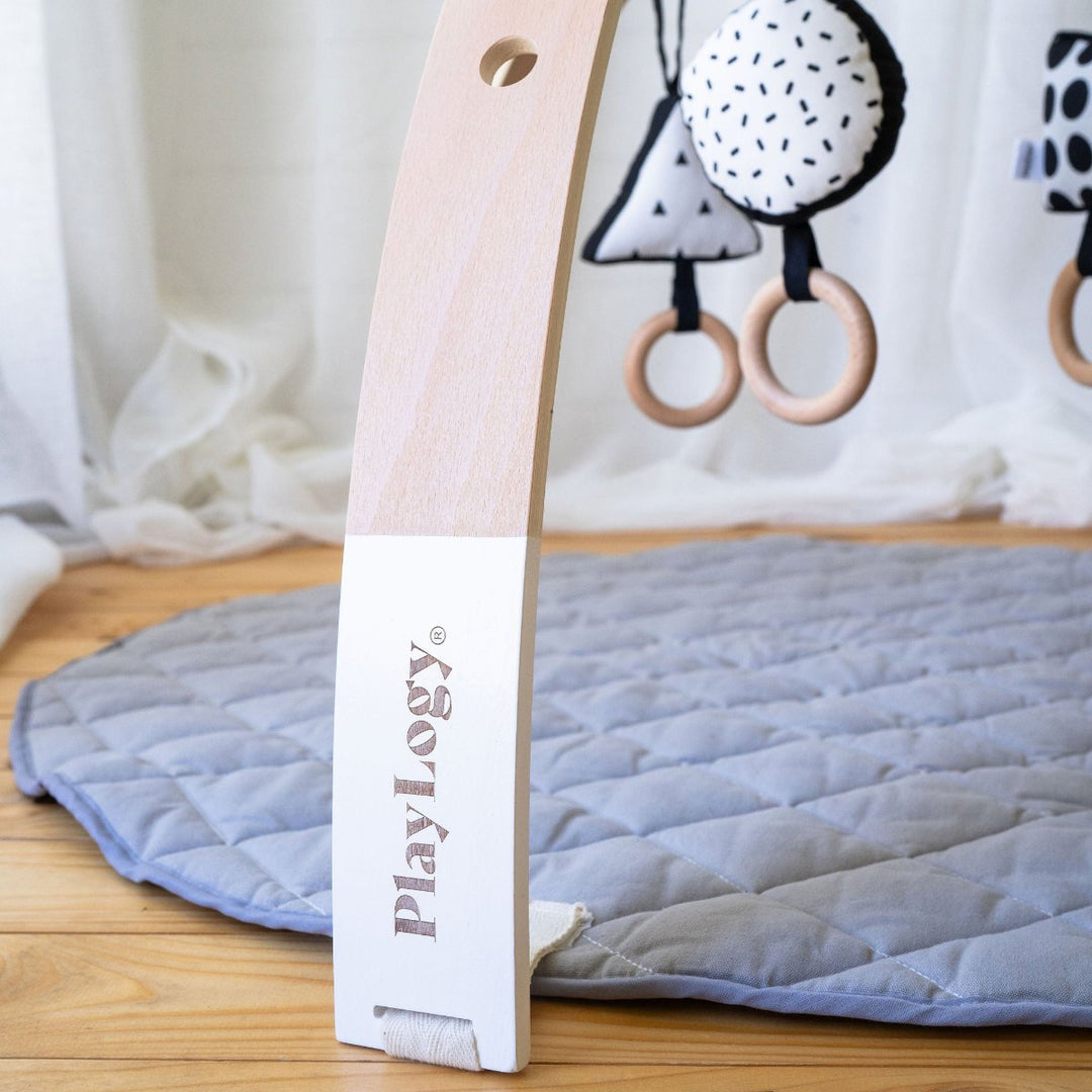 Wooden playgym with grey playmat for newborns