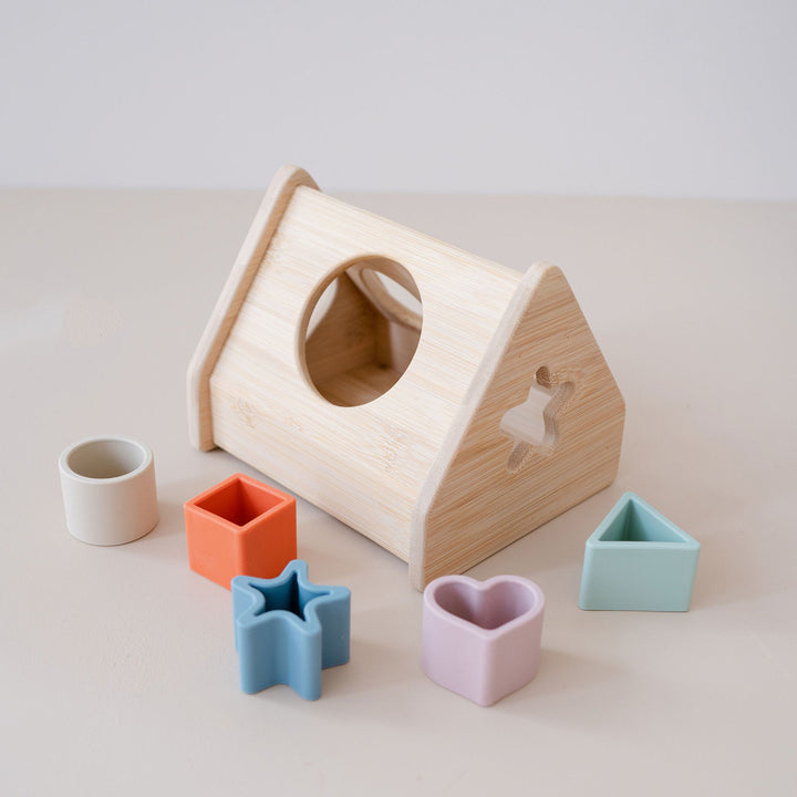 Wooden shape sorter house with soft shapes