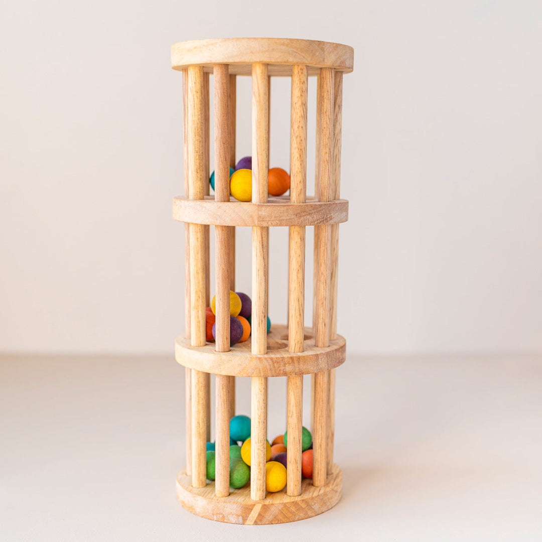 Wooden Rain Maker toy with coloured beads inside.